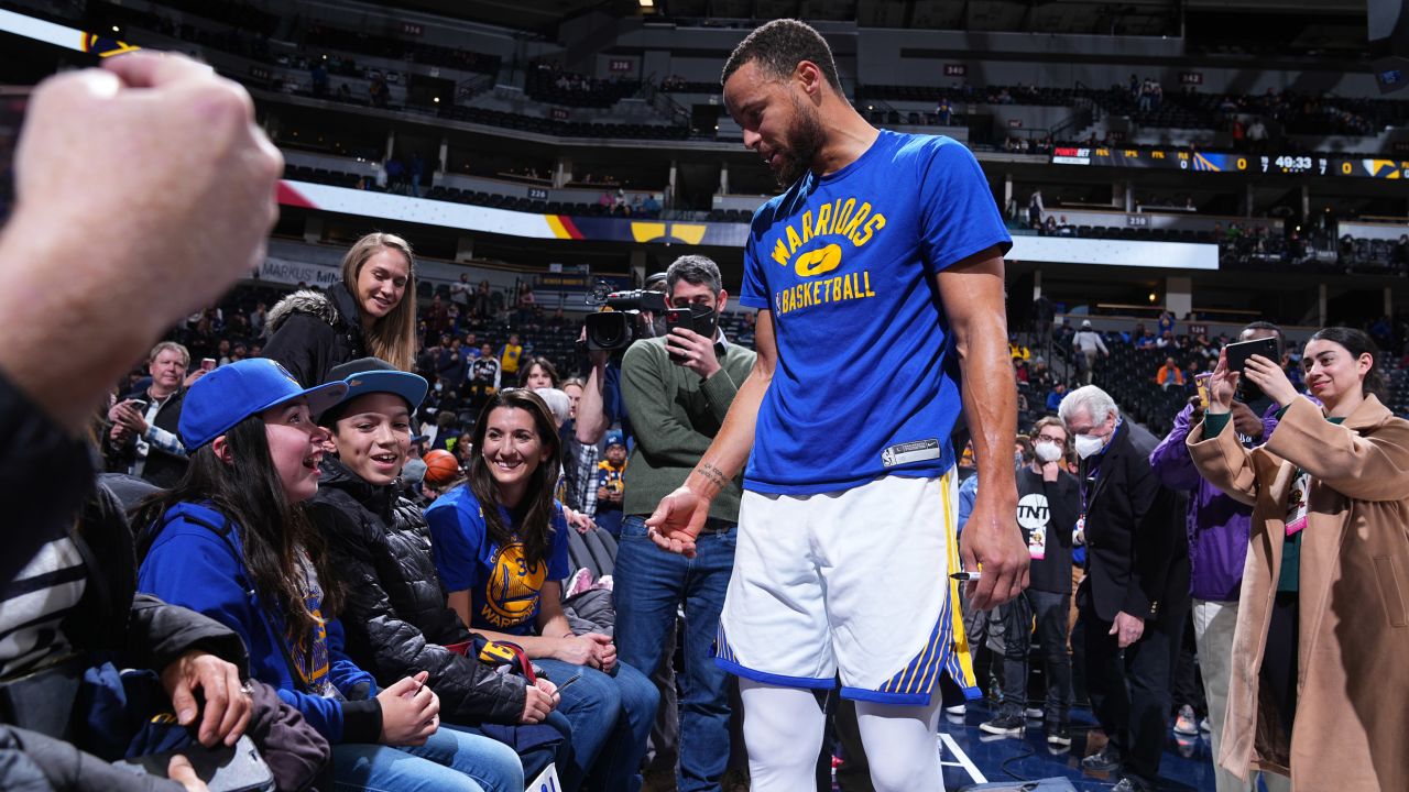Steph Curry greets young fan, PJ O'Byrne, before the game against the Denver Nuggets in Denver, Colorado.