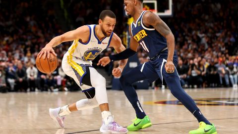 Curry drives against Monte Morris of the Denver Nuggets in the first half.