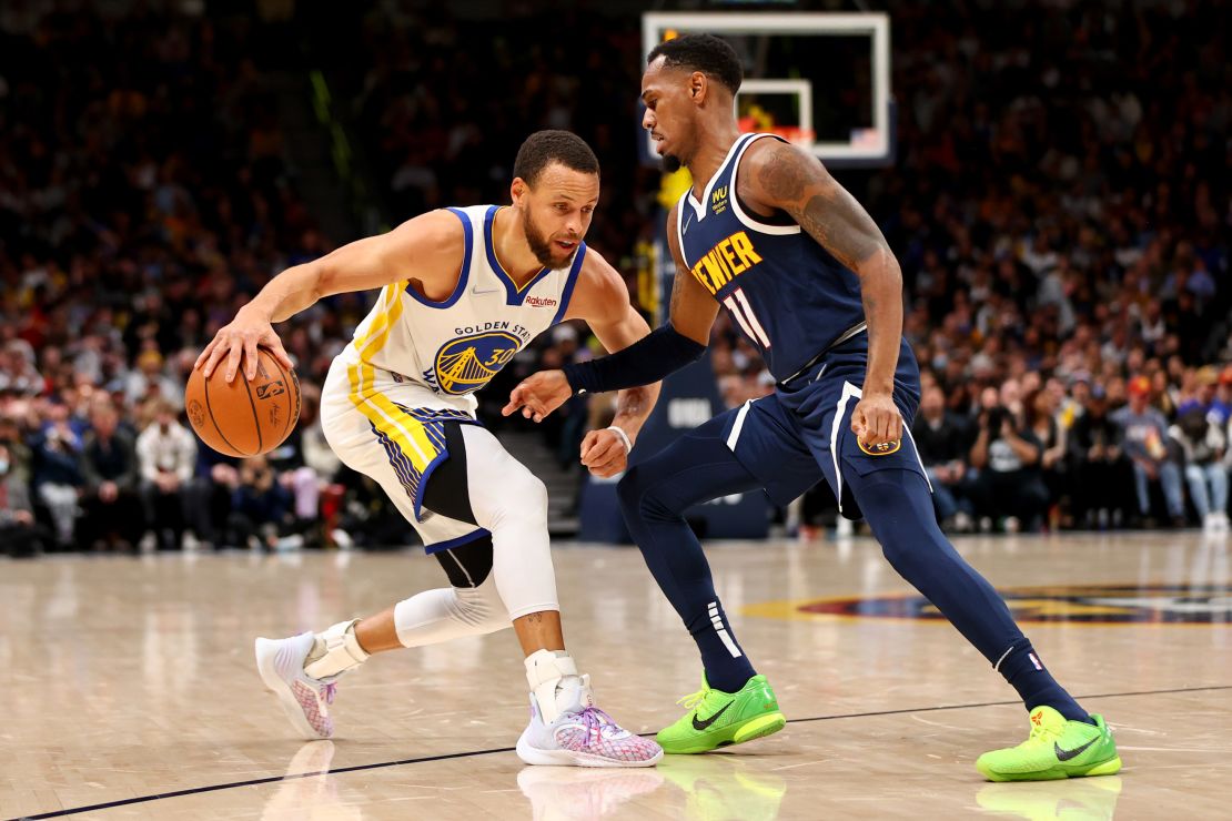 Curry drives against Monte Morris of the Denver Nuggets in the first half.
