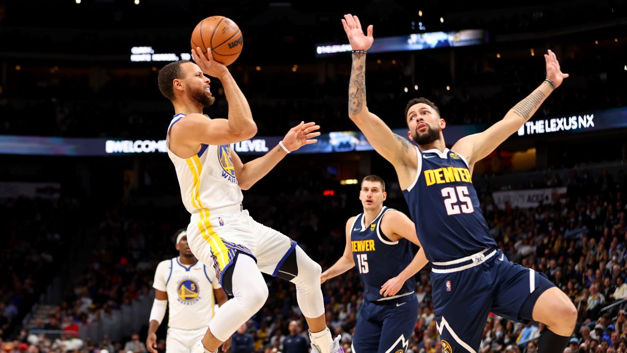 Curry drives against Austin Rivers of the Denver Nuggets.