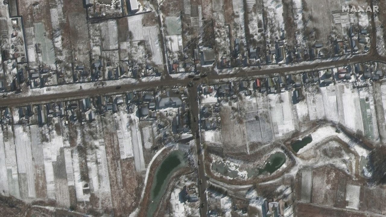 Russian military vehicles are seen sitting on roadways in residential areas in Ozera.