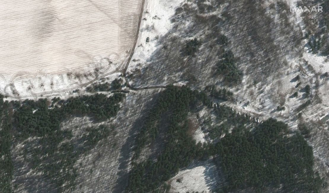 Towed artillery and other vehicles are seen taking cover in a sparse patches of trees near Lubyanka.