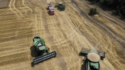 FILE - Farmers harvest with their combines in a wheat field near the village Tbilisskaya, Russia, July 21, 2021. The Russian tanks and missiles besieging Ukraine also are threatening the food supply and livelihoods of people in Europe, Africa and Asia who rely on the vast, fertile farmlands known as the "breadbasket of the world." Russia and Ukraine combine for about a third of the world's wheat and barley exports and provide large amounts of corn and cooking oils. (AP Photo/Vitaly Timkiv, File)