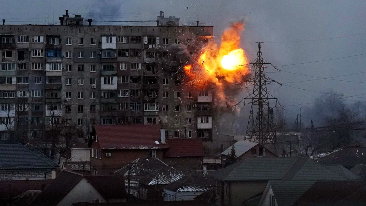 An explosion is seen at an apartment building in Mariupol on March 11. The city in southeastern Ukraine has been <a target=