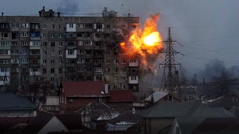 An explosion is seen at an apartment building in Mariupol on March 11. The city in southeastern Ukraine has been besieged by Russian forces.