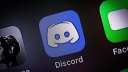 The Discord app is seen on an iPhone in this photo illustration in Warsaw, Poland on April 3, 2021. The communications and messaging platform Discord is reportedly in talks with Microsoft to sell it's platform. According to gaming tech website GamesBeat the sale could result in a USD 10 billion takeover. With over 9 million daily users Discord easily beats workplace messaging app Slack which attracted just over 2 million daily users at it's start. Microsoft could possibly integrate Discord with it's Xbox gaming platform as the app initially became popular with gamers. (Photo by Jaap Arriens/NurPhoto via Getty Images)