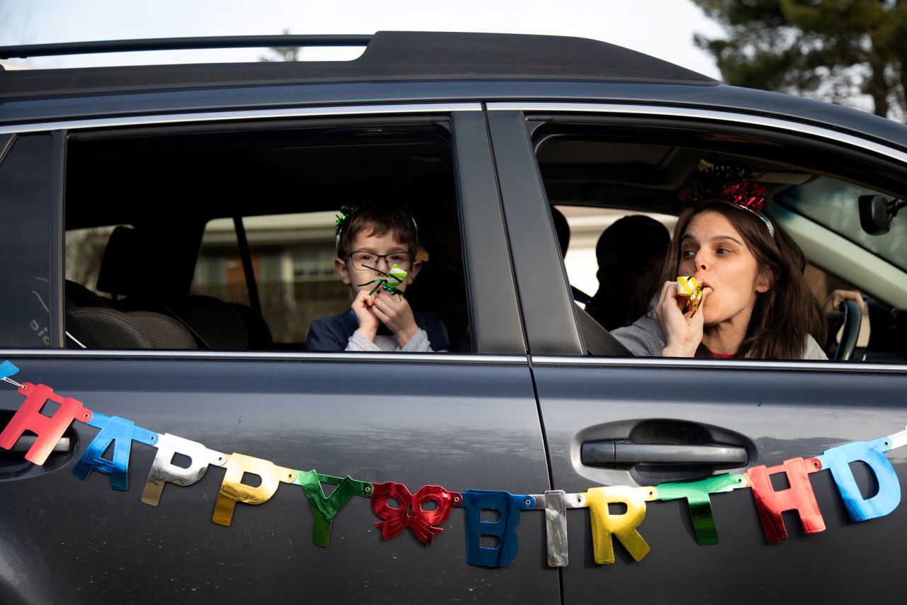 Dana Baer and her son Jacob wish Avery Slutsky a happy sixth birthday from their car in West Bloomfield Township, Michigan, in March 2020. Americans with pandemic birthdays would often hold drive-by celebrations instead of formal parties to keep friends safe without sacrificing fun.