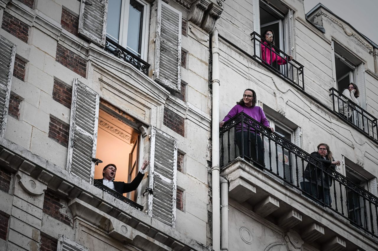 Opera singer Stephane Senechal sings for his neighbors from his apartment window in Paris in March 2020. It was the 10th day of a strict lockdown in France, and residents got creative to keep each other entertained.
