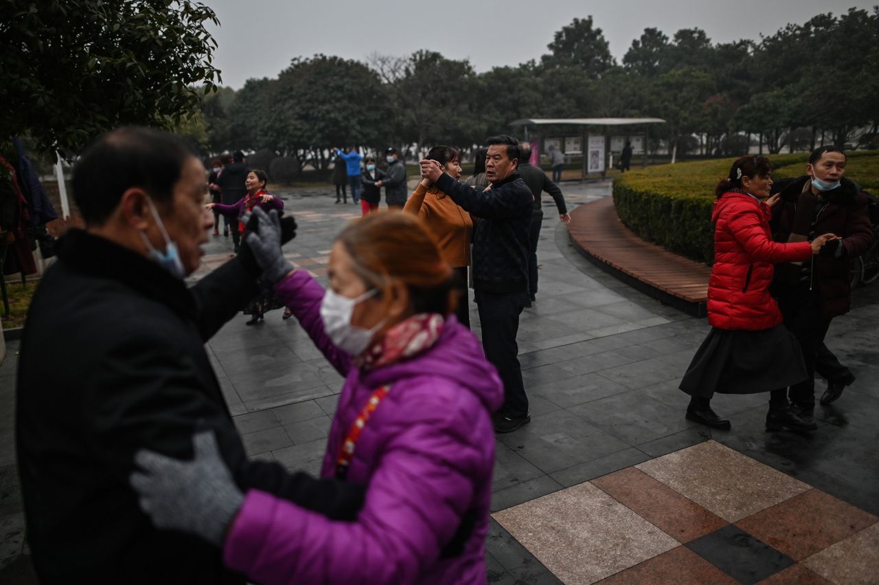 People dance in a park in Wuhan, China's central Hubei province, on January 23, 2021, one year after the city went into lockdown to curb the spread of Covid-19. 