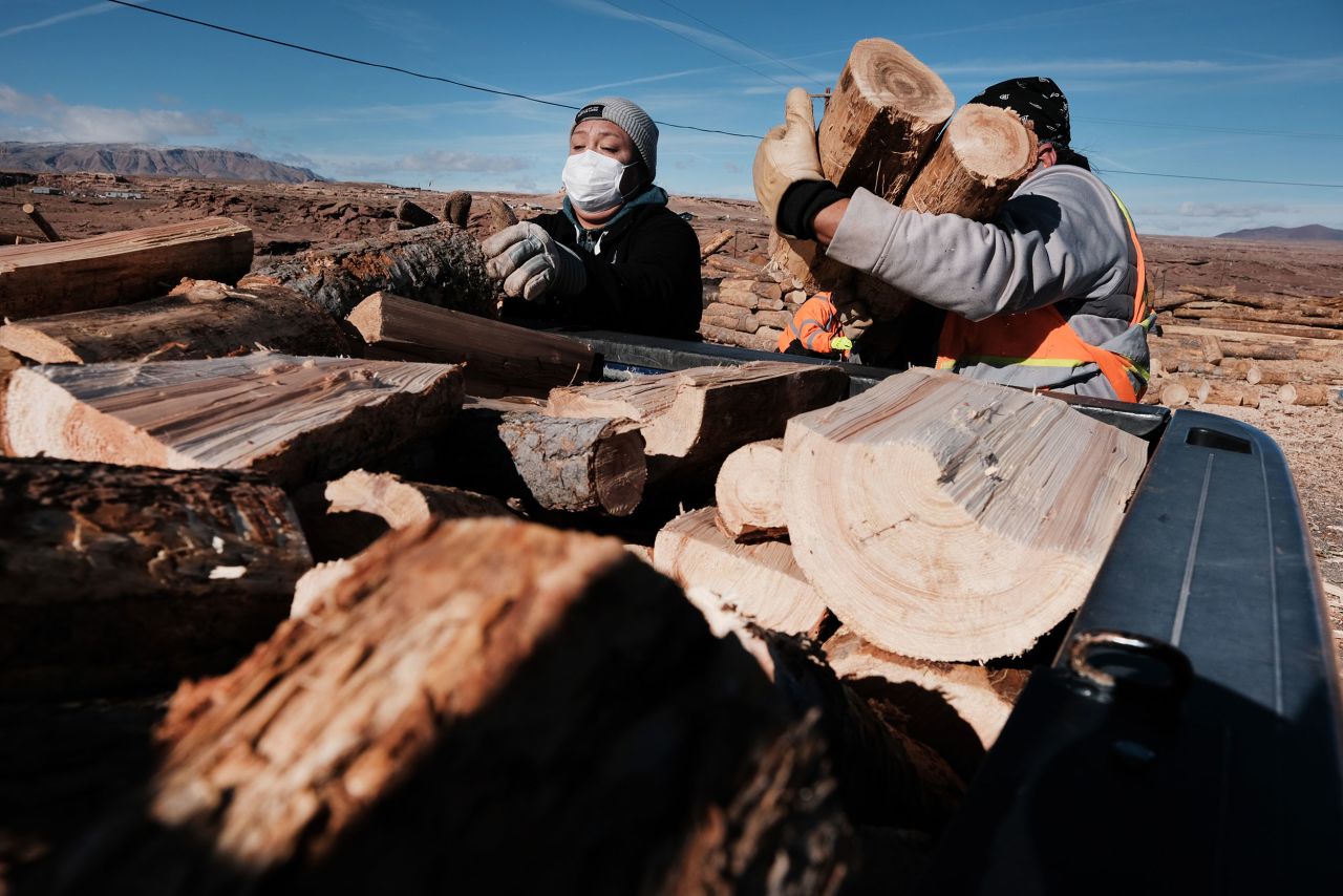 Members of the Navajo community place cut wood used for cooking and heating into a truck on a reservation in December 2021 in Arizona. The wood, thinned from unhealthy forests in the area, was accessed through a partnership with the National Forest Foundation and their 'Wood for Life' initiative. 