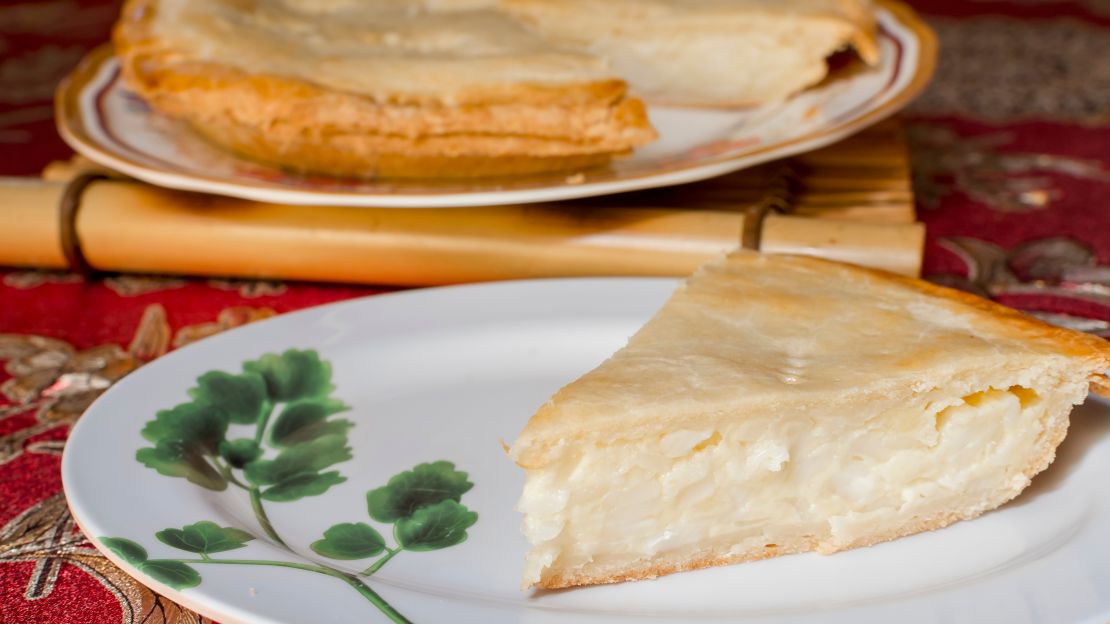 A slice of buko pie, a Filipino-style coconut pie made of fresh, tender coconut meat combined with creamy filling and enclosed in a flaky pie crust.