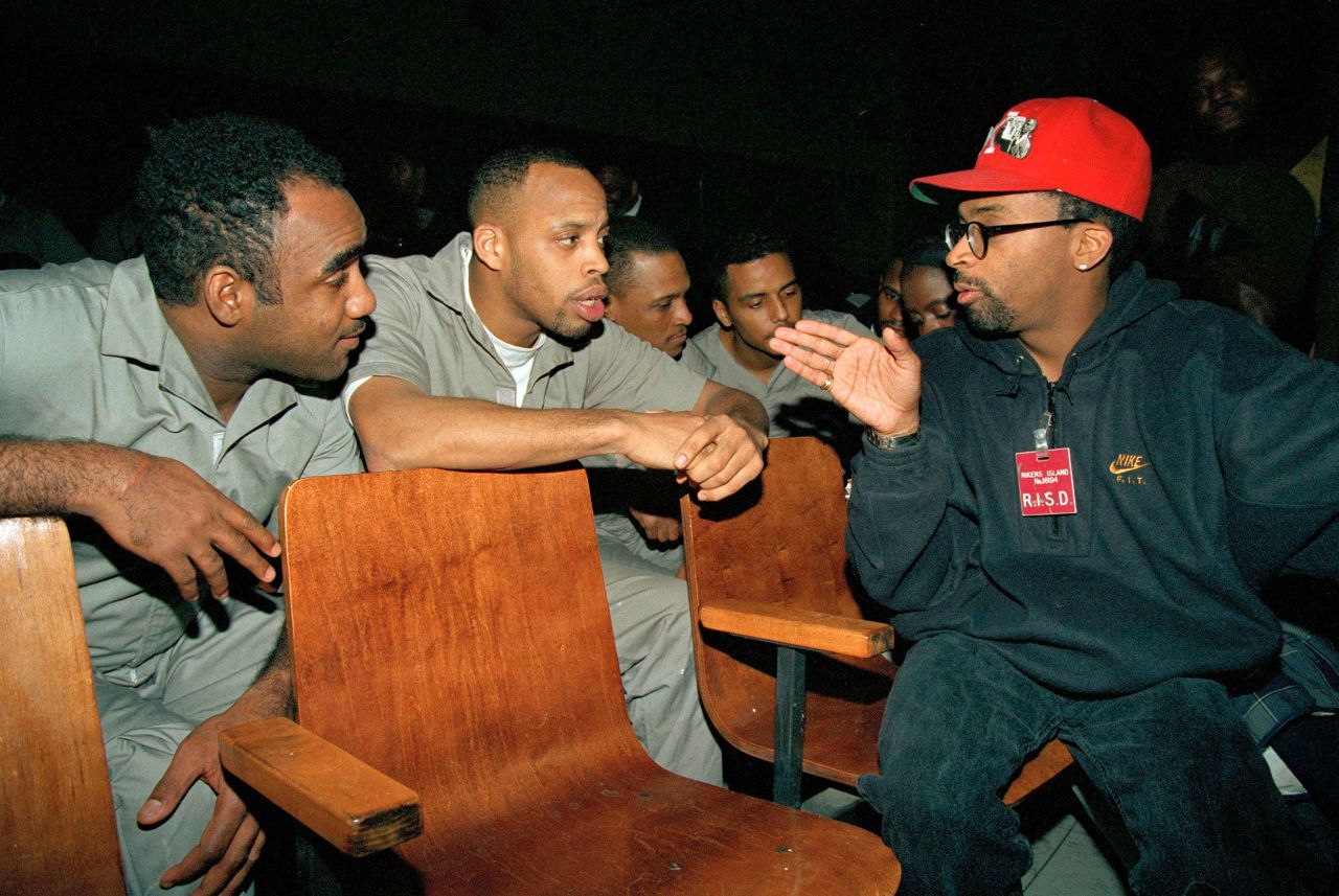 Lee speaks to Rikers Island inmates Ivan Rennie, left, and Rodney Veeney while visiting the maximum security prison in New York in 1993. Lee was screening his film "Malcolm X" on the 28th anniversary of his assassination.