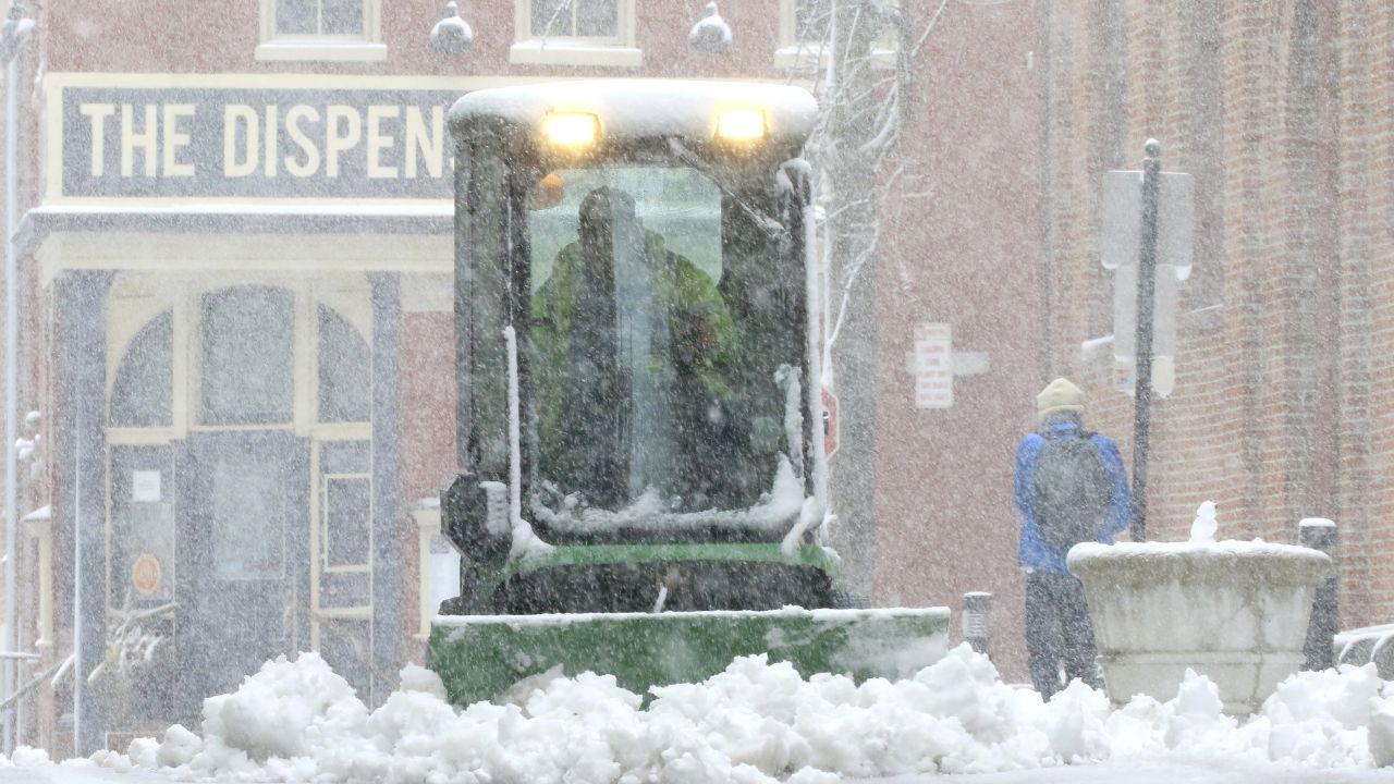 A city worker plows the sidewalk near Lancaster's Central Market Saturday in Lancaster, Pennsylvania. 