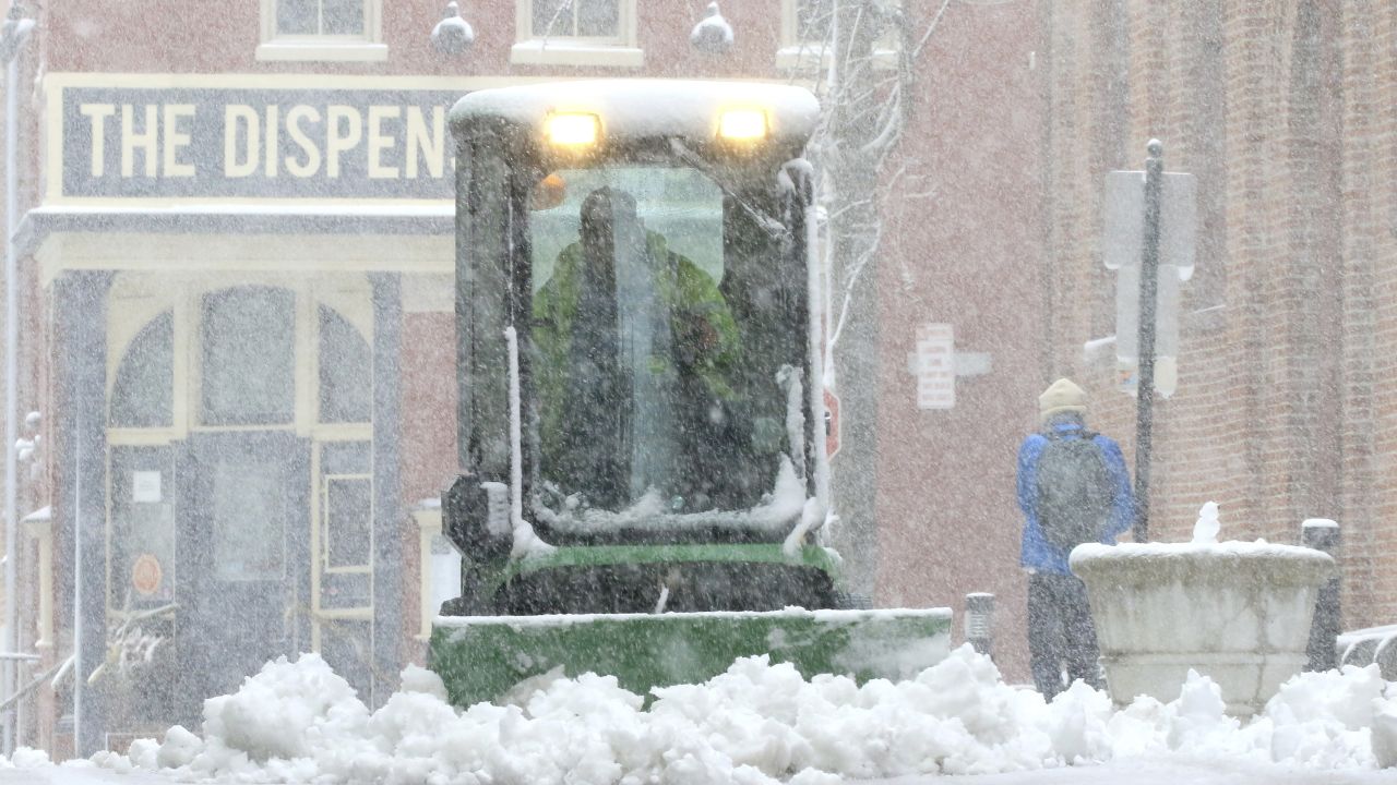 A city worker plows the sidewalk near Lancaster's Central Market Saturday in Lancaster, Pennsylvania.