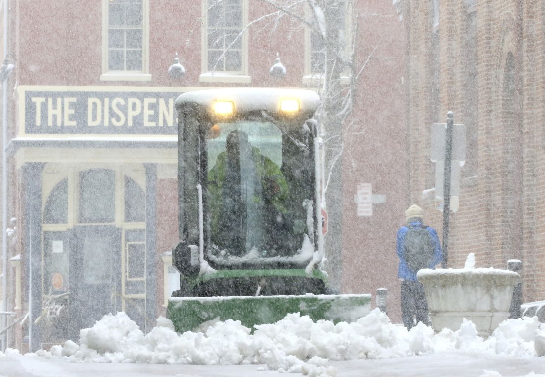 A city worker plows the sidewalk near Lancaster's Central Market Saturday in Lancaster, Pennsylvania. 