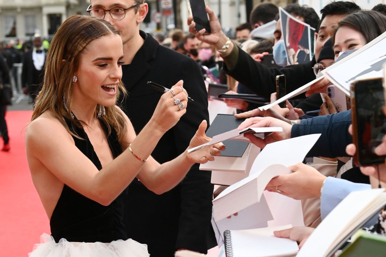 Actress Emma Watson signs autographs for fans.