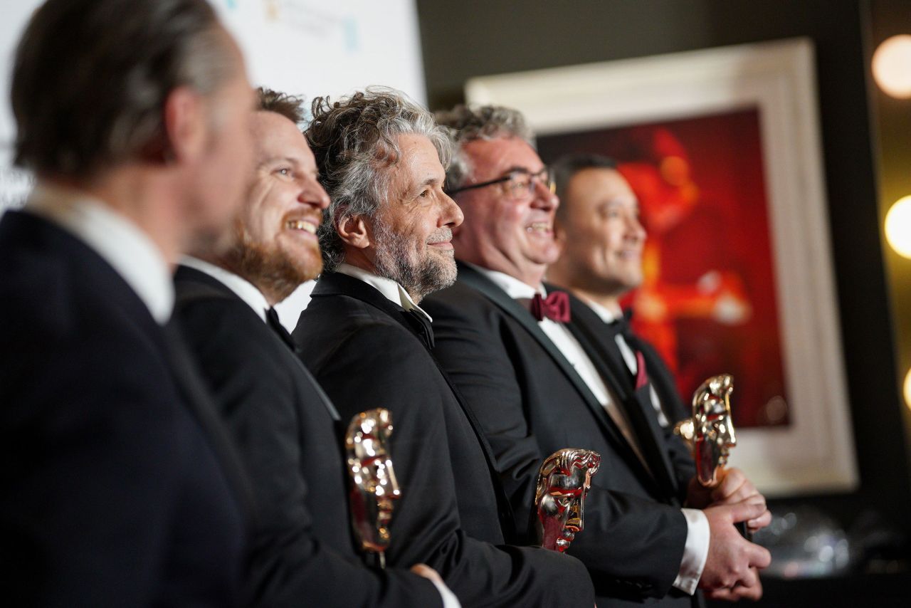 Visual effects artists Tristan Myles, Paul Lambert, Gerd Nefzer and Brian Connor pose with the BAFTAs they won for their work on the film "Dune."