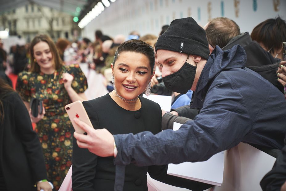 A fan takes a selfie with actress Florence Pugh.
