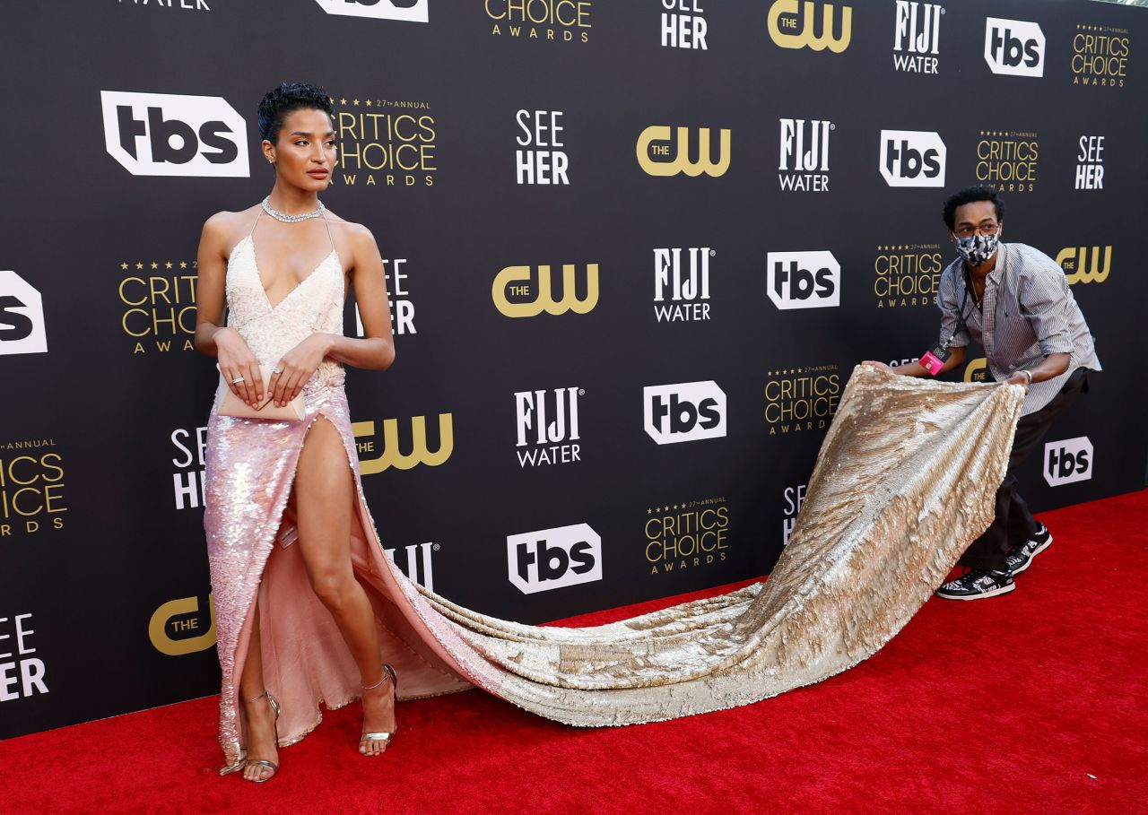 Indya Moore gets some help with her dress while walking the red carpet.