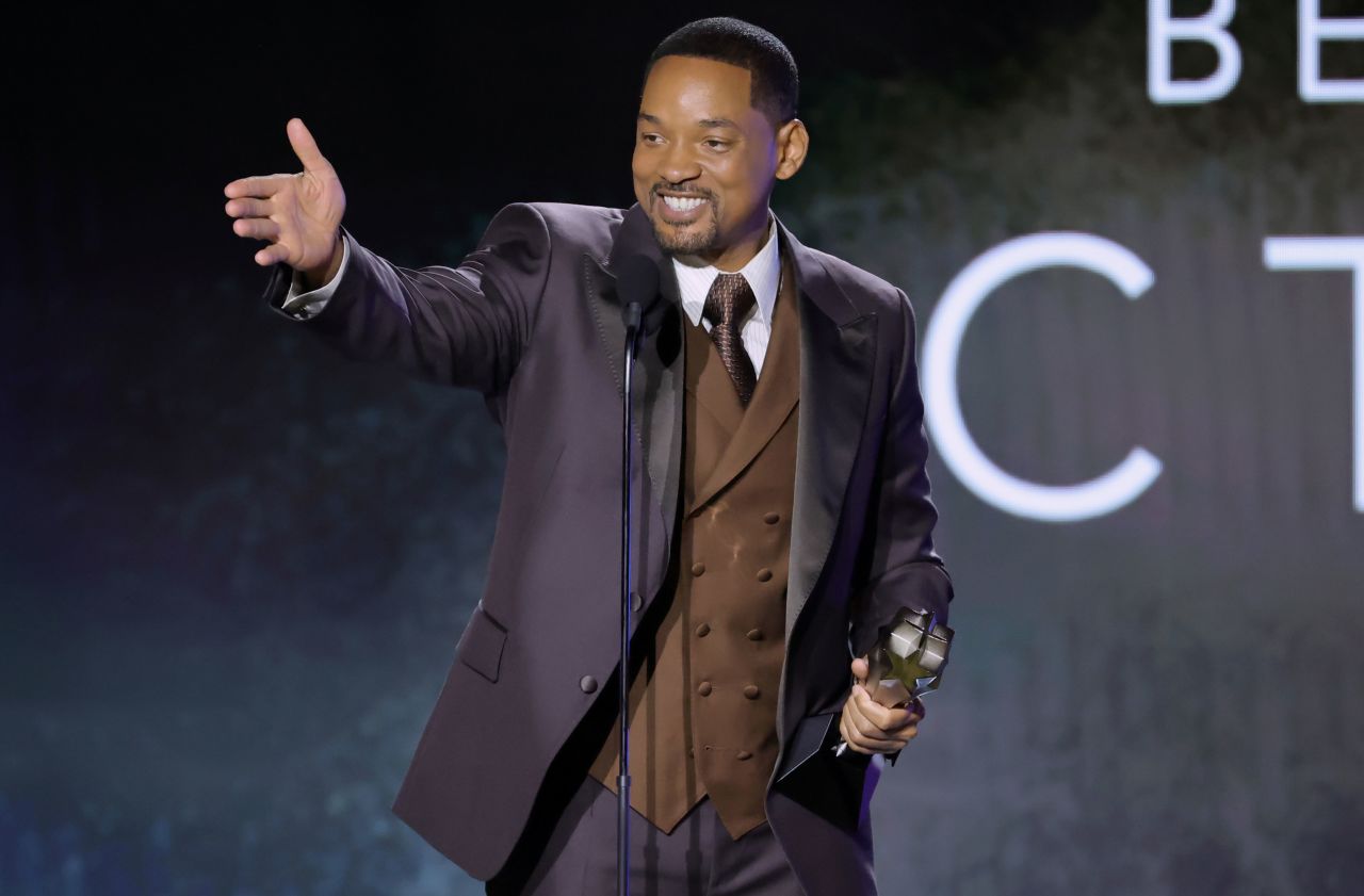 Will Smith accepts a best actor award for his role in the film "King Richard."
