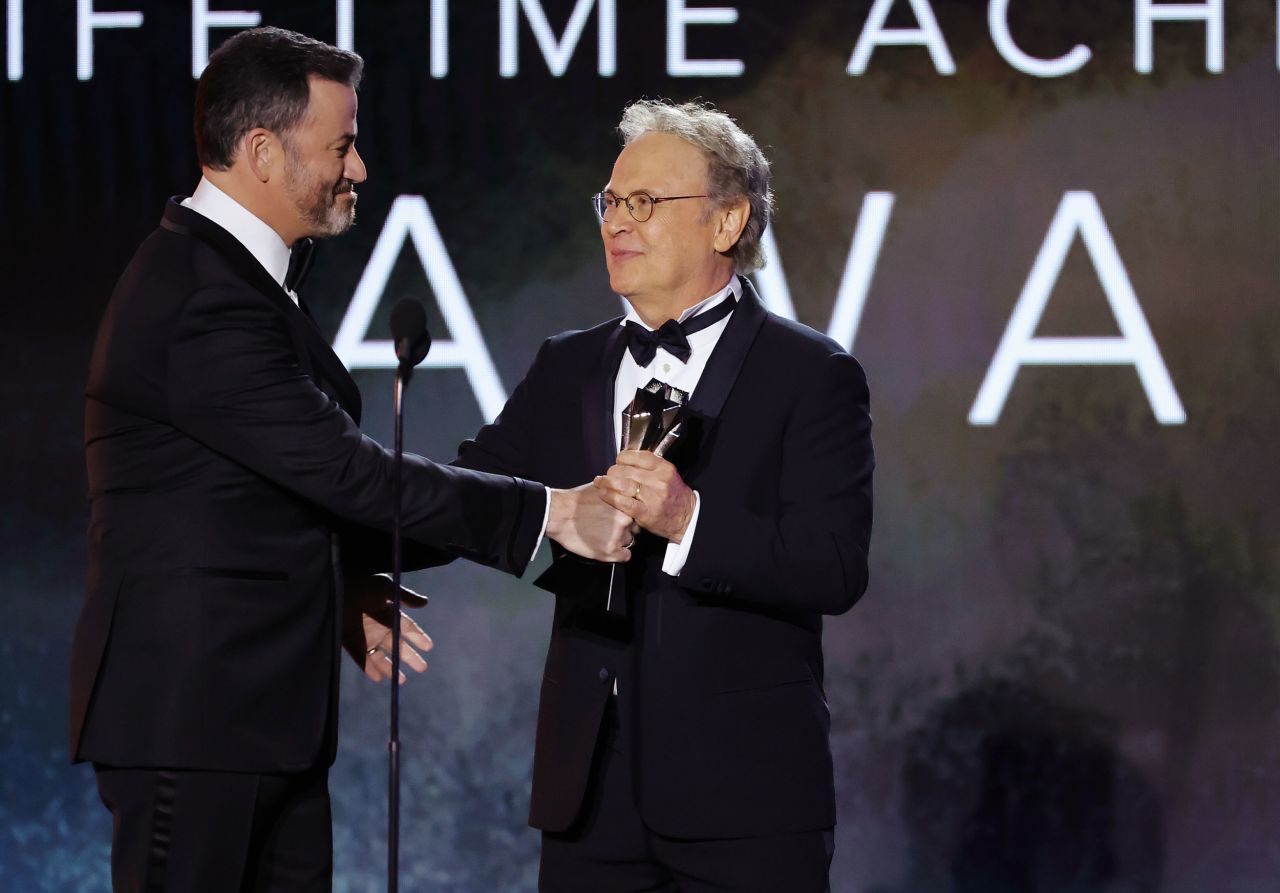 Talk-show host Jimmy Kimmel presents Billy Crystal with a lifetime achievement award.