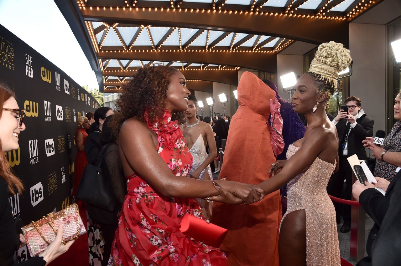 Issa Rae, left, and Angelica Ross greet each other on the red carpet.