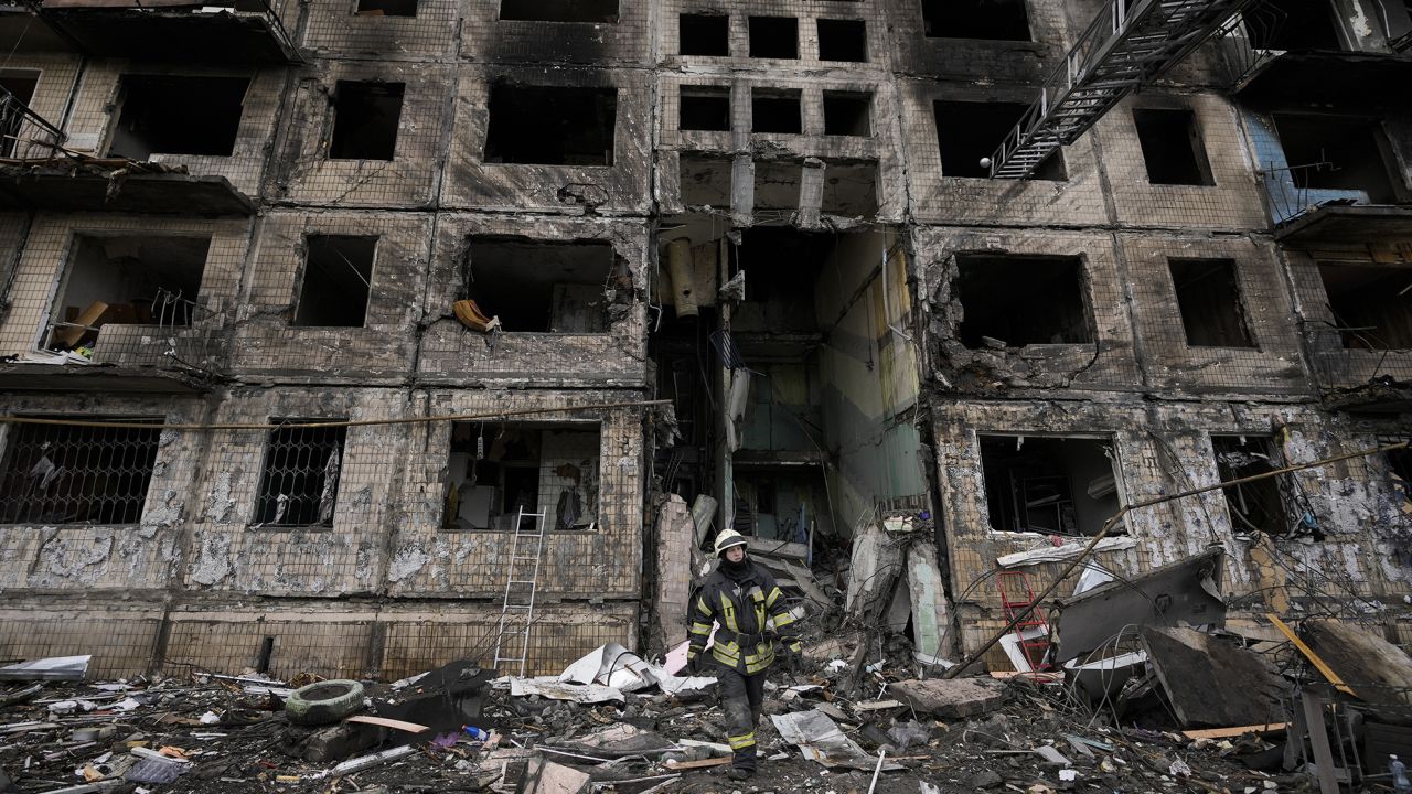 Damage is seen to an apartment building in Kyiv which was hit by shelling.