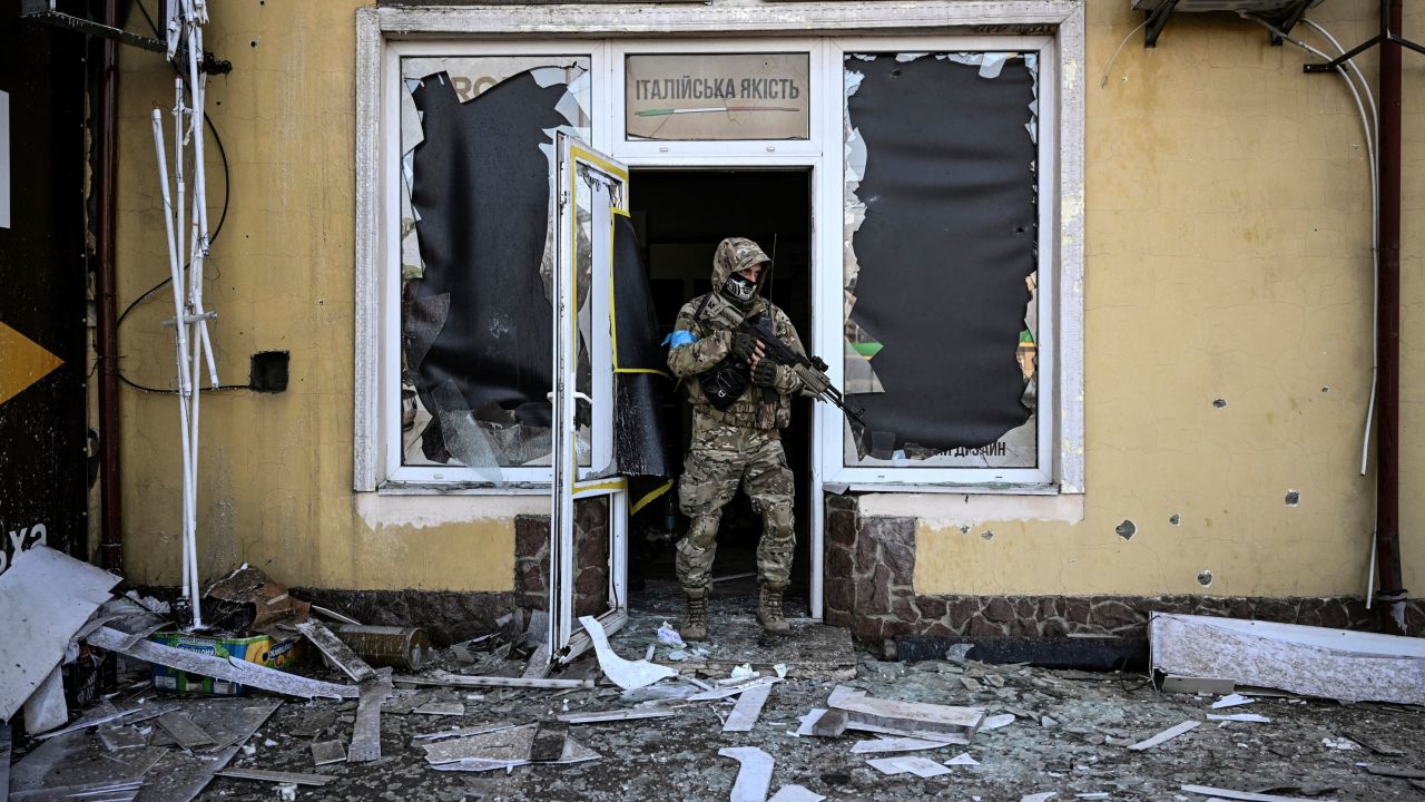 A Ukrainian serviceman exits a damaged building after shelling in Kyiv on Saturday.
