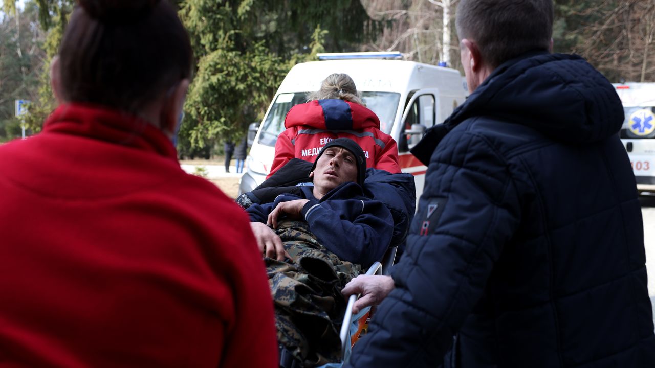 Medical staff treat a man wounded in strikes at the Yavoriv military base in western Ukraine.