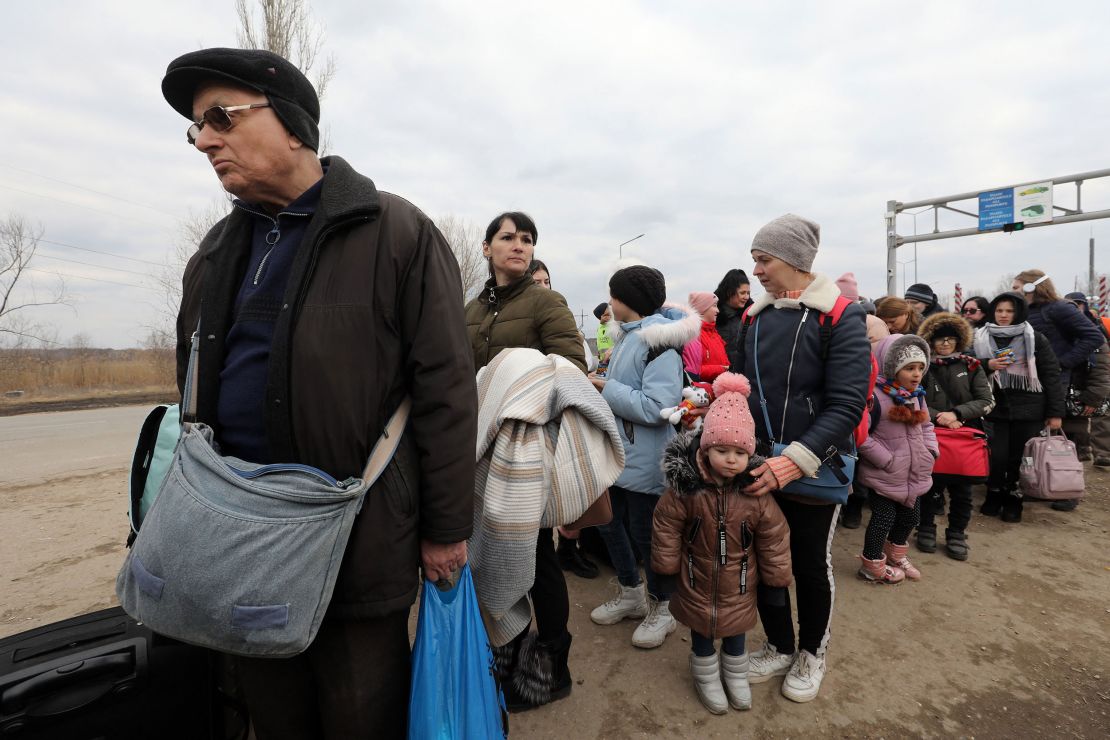 People fleeing the conflict in Ukraine cross the  Moldova-Ukraine border checkpoint near the town of Palanca, on March 14, 2022, after Russia' military invasion of Ukraine. 