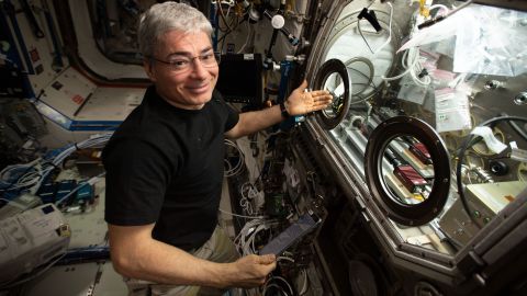 NASA astronaut and Expedition 66 Flight Engineer Mark Vande Hei sets up hardware on the International Space Station.