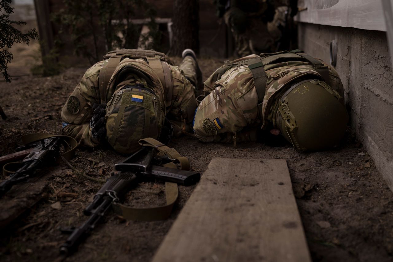 Ukrainian soldiers take cover from incoming artillery fire in Irpin, Ukraine, on March 13.  Zelensky says Russia waging war so Putin can stay in power &#8216;until the end of his life&#8217; w 1280
