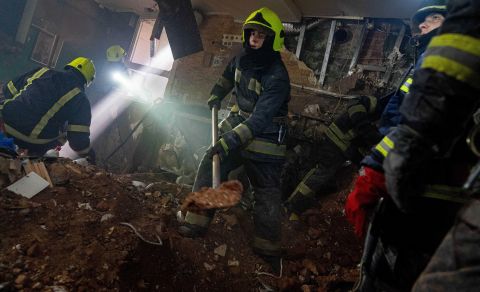 Firefighters search a building for survivors after an attack in Kharkiv, Ukraine, on March 14. At least one dead body was pulled from the rubble after hours of digging.