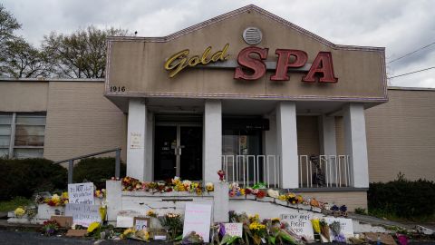 Flowers adorn Gold Spa after a series of shootings at Atlanta-area spas that left eight people, six of them Asian women, dead.