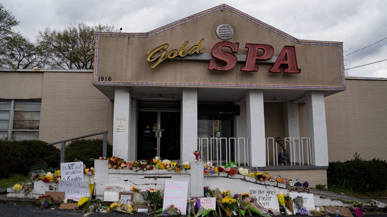 Flowers adorn Gold Spa after a series of shootings at Atlanta-area spas that left eight people, six of them Asian women, dead.