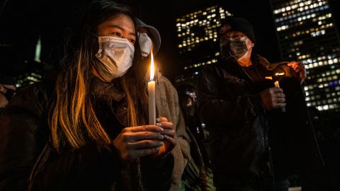 A woman holds a candle during a January 18 vigil in San Francisco for Michelle Go.