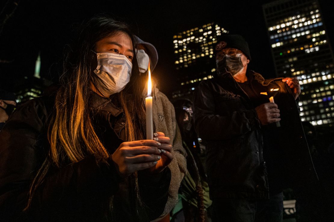 A woman holds a candle during a January 18 vigil in San Francisco for Michelle Go.