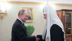 Russian President Vladimir Putin presents flowers to Patriarch of Moscow and All Russia Kirill on the occasion of the 11th anniversary of his enthronement in Moscow on February 1, 2020. 