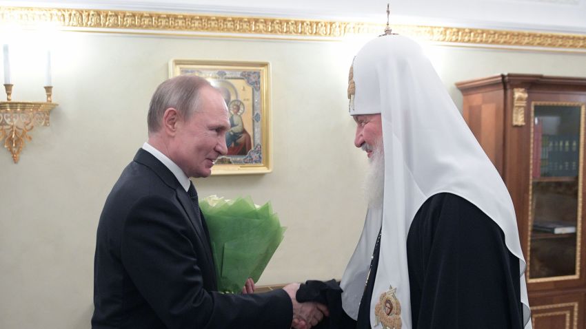 Russian President Vladimir Putin presents flowers to Patriarch of Moscow and All Russia Kirill on the occasion of the 11th anniversary of his enthronement in Moscow on February 1, 2020. 