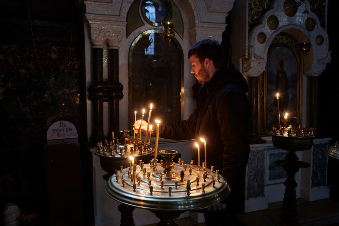 A man lights a candle in an Orthodox Church in Kyiv, Ukraine on February 24.