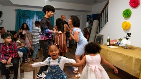 Dancing at home to music is an easy way to stay active. (Center midground, from left) Carlos De Los Santos, 17, dances with his sister Alba Sanchez, 22, during a celebration of her college graduation. 