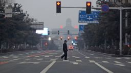 CHANGCHUN, CHINA - MARCH 14 2022: A man walks across an empty road in Changchun in northeast China's Jilin province Monday, March 14, 2022, the fourth day of the Covid-19 lockdown. (Photo credit should read Feature China/Future Publishing via Getty Images)