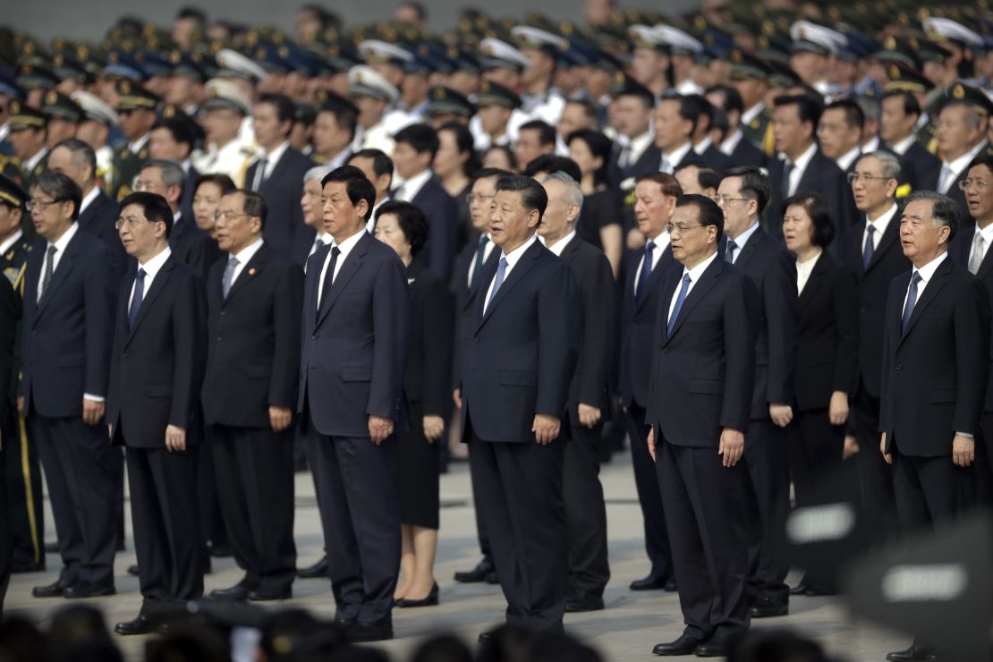 Chinese President Xi Jinping, center, and other officials sing the Chinese national anthem during a ceremony to mark Martyr's Day at Tiananmen Square in Beijing, in September 2019. 