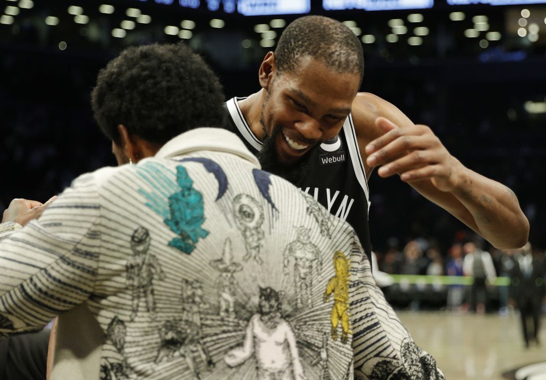 Kevin Durant and Kyrie Irving embrace after the Nets' win against the Knicks.