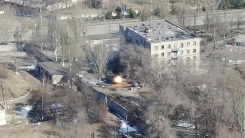 This screengrab from the drone footage shows a military vehicle shooting rounds close to a building.