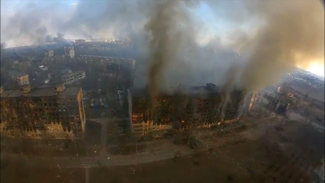 Smoke rises from damaged residential buildings.