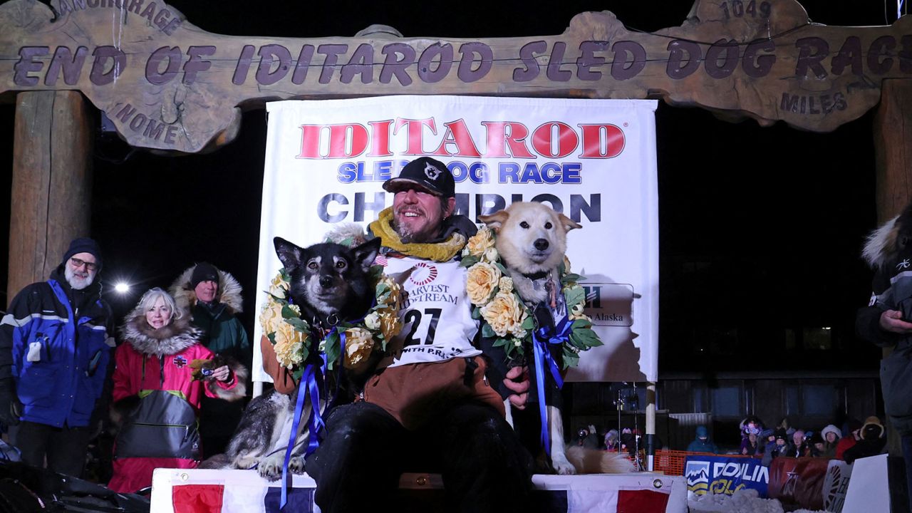 Veteran musher Brent Sass of Eureka, Alaska holds his lead dogs Slater and Morello after winning his first Iditarod Trail Sled Dog Race championship in Nome, Alaska, U.S. March 15, 2022. 
