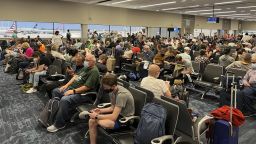 Passengers wait at Fort Lauderdale FLL Airport Terminal 2 on March 12, 2022. Terminal 2 is sometimes called the "Delta Terminal" and is also used Air Canada. 
