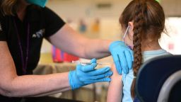 A nurse administers a pediatric dose of the Covid-19 vaccine to a girl at a L.A. Care Health Plan vaccination clinic at Los Angeles Mission College in the Sylmar neighborhood in Los Angeles, California, January 19, 2022. - While cases of Covid-19 hospitalizations and deaths continue to rise in California, officials are seeing early signs that the Omicron surge is slowing. (Photo by Robyn Beck / AFP) (Photo by ROBYN BECK/AFP via Getty Images)