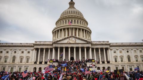 Pro-Trump protesters stand on the East steps of the Capitol Building after storming its grounds on January 6, 2021, in Washington. 